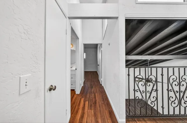 a view of hallway with wooden floor and stairs