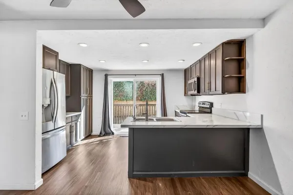 a kitchen with stainless steel appliances a sink stove and refrigerator