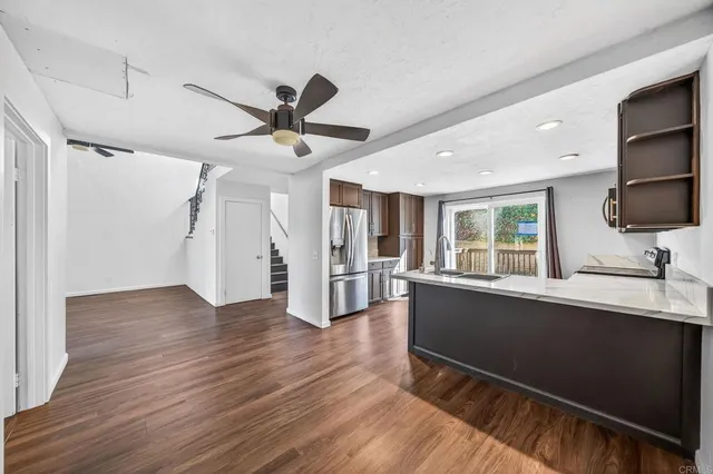 a kitchen with wooden floors and white walls