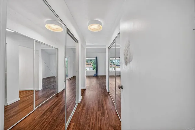 a view of a hallway with wooden floor