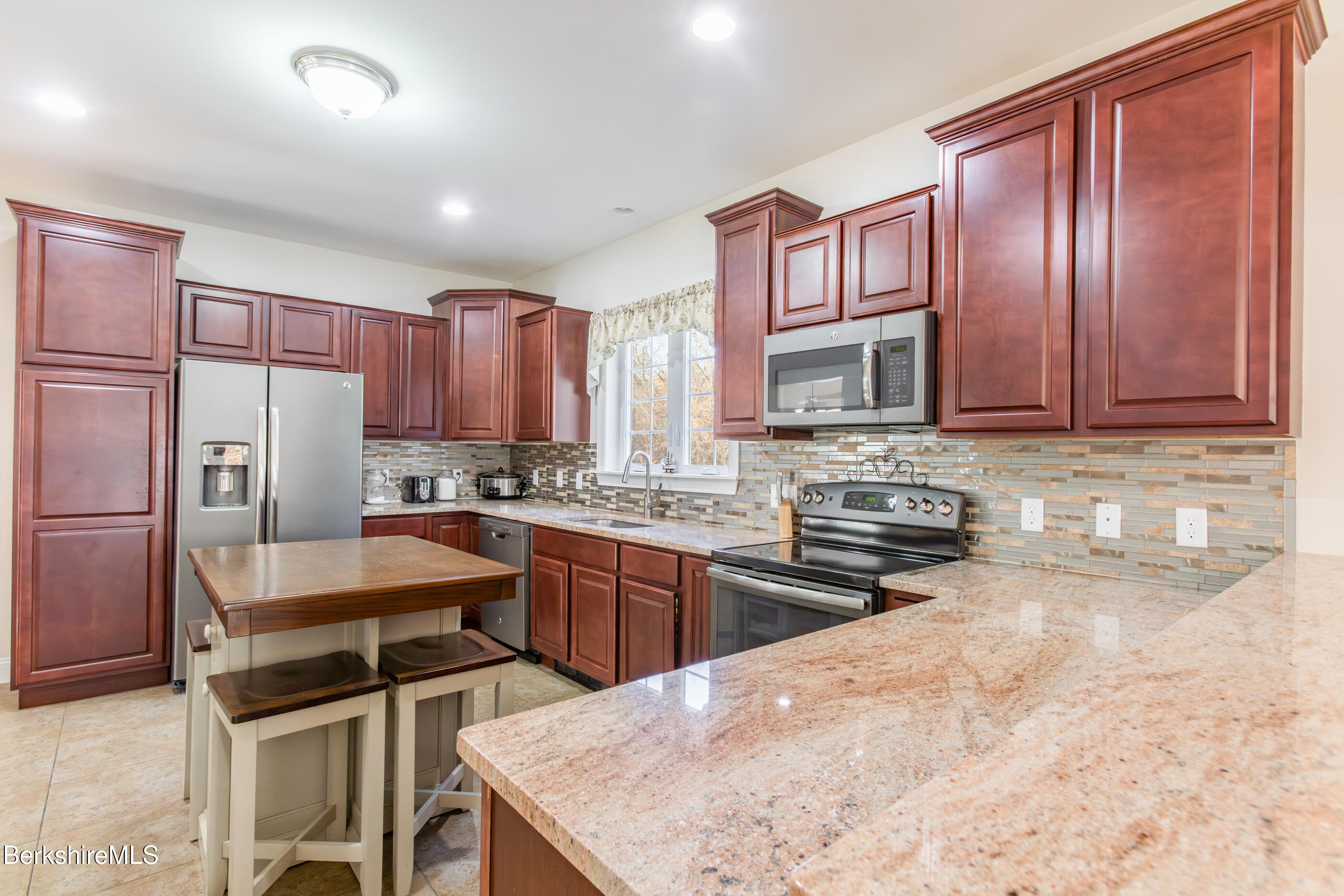 60 Middlefield Road Washington, MA 01223 - Photo 33 of 55 a kitchen with stainless steel appliances granite countertop a stove a sink dishwasher a refrigerator and cabinets with wooden floor