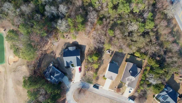 an aerial view of houses with yard