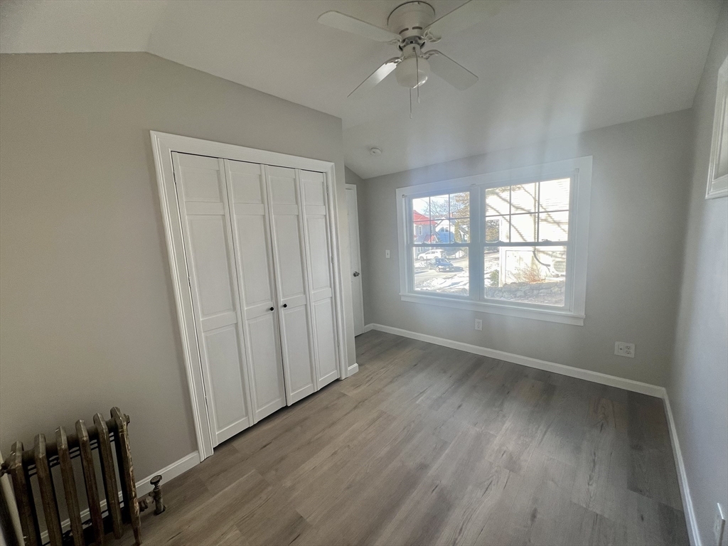 24 Proctor Street Worcester, MA 01606 - Photo 13 of 25 wooden floor in an empty room with a window
