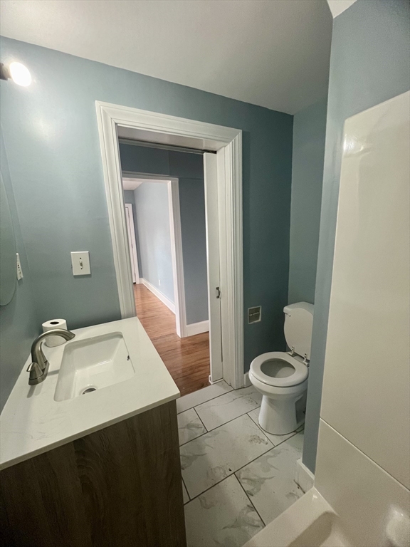 24 Proctor Street Worcester, MA 01606 - Photo 20 of 25 a bathroom with a sink a toilet and a mirror