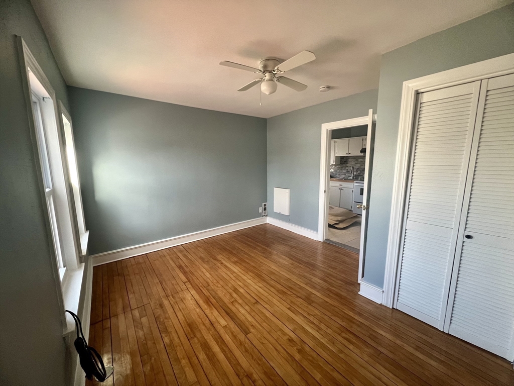 24 Proctor Street Worcester, MA 01606 - Photo 21 of 25 wooden floor in an empty room with a window