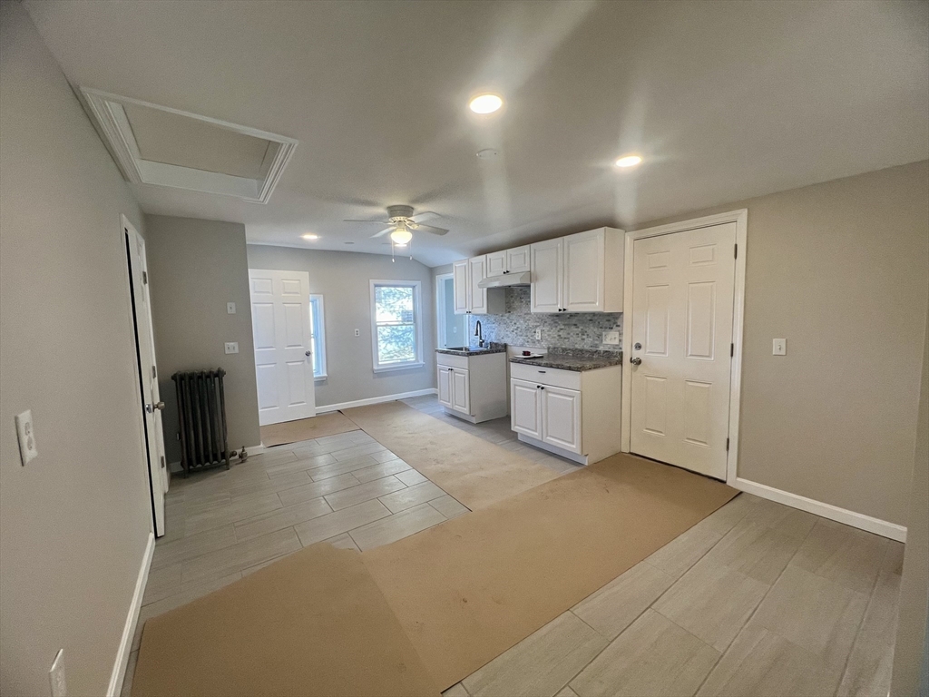 24 Proctor Street Worcester, MA 01606 - Photo 5 of 25 a view of a kitchen with a sink and a refrigerator