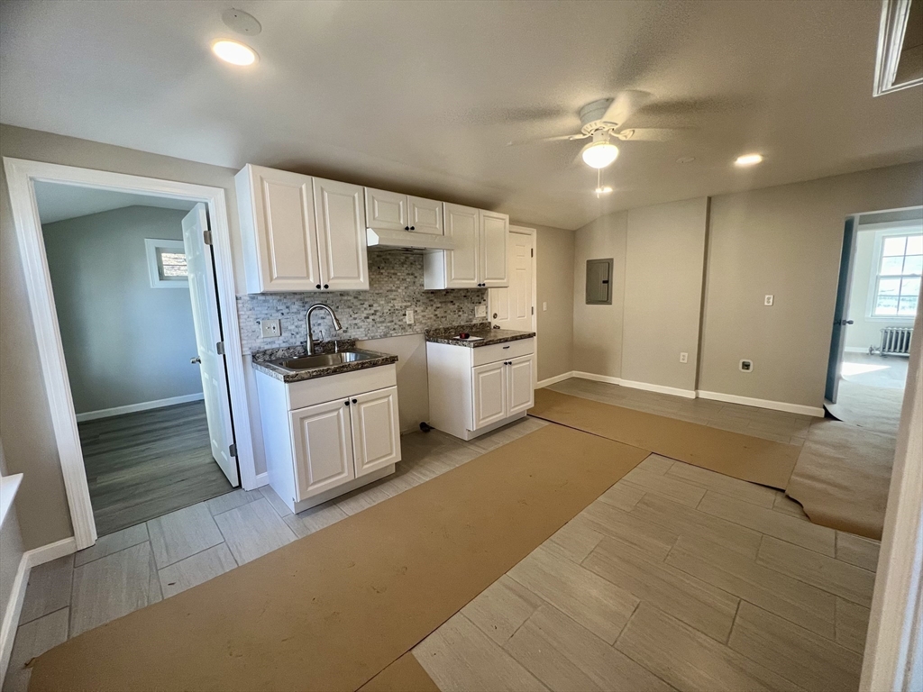 24 Proctor Street Worcester, MA 01606 - Photo 6 of 25 a kitchen with a sink stove and cabinets