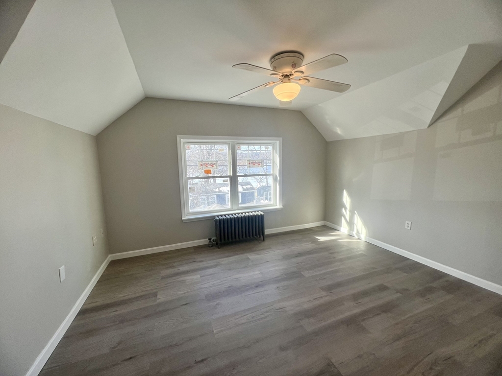 24 Proctor Street Worcester, MA 01606 - Photo 8 of 25 an empty room with wooden floor chandelier and windows