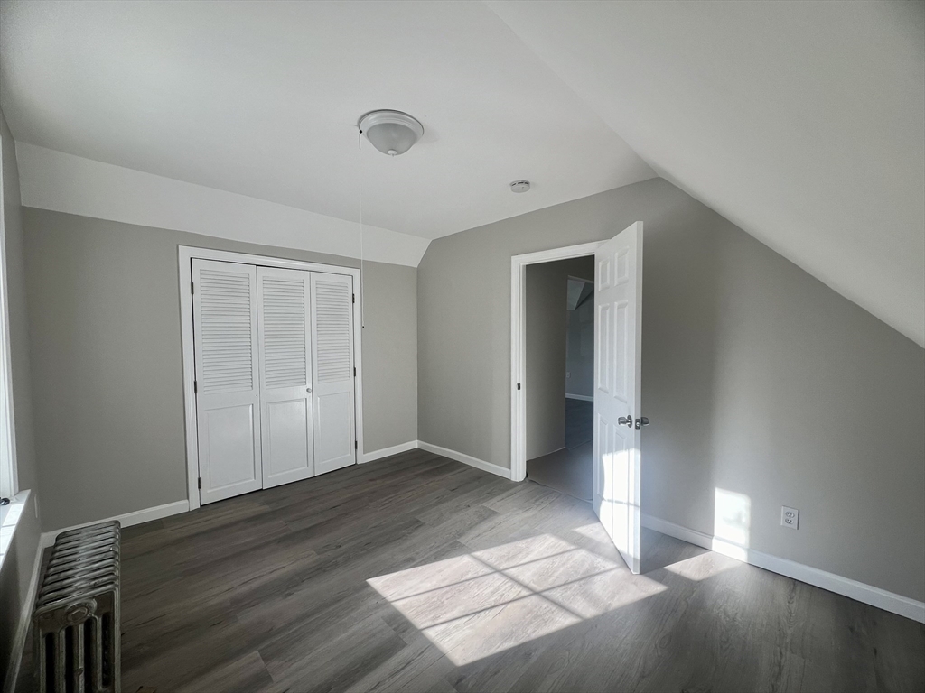 24 Proctor Street Worcester, MA 01606 - Photo 10 of 25 a view of an empty room with wooden floor and closet