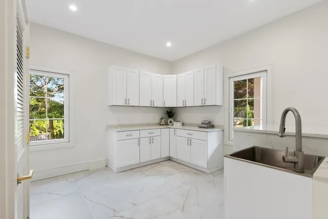 a kitchen that has a sink and a stove in it