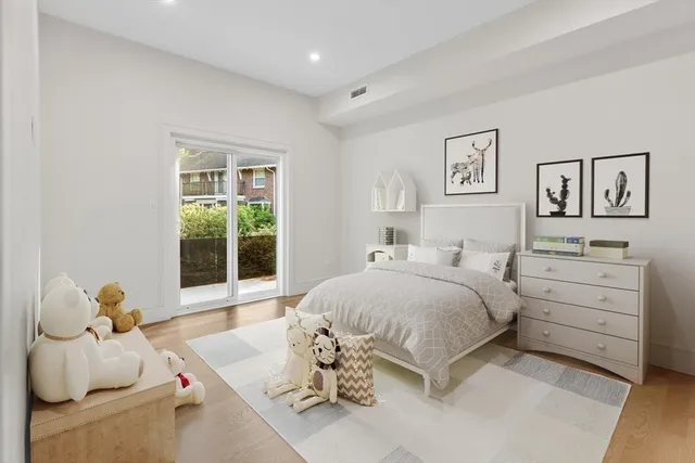 a spacious bedroom with a bed and a window