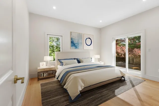 a bedroom with a bed and a large window