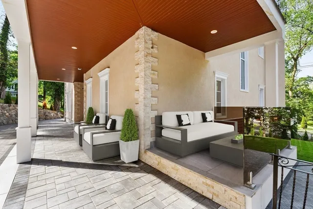 a balcony with furniture and a potted plant