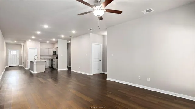 a view of an empty room with kitchen appliances