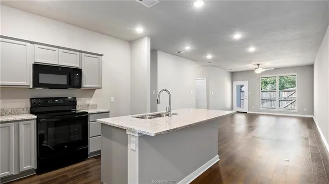 a kitchen with a sink stainless steel appliances and cabinets