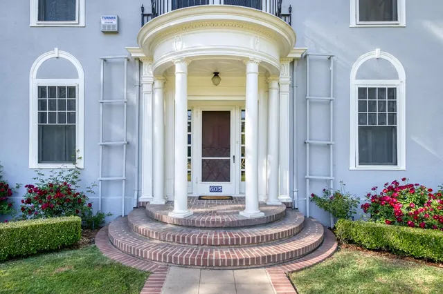 a front view of a house with a garden