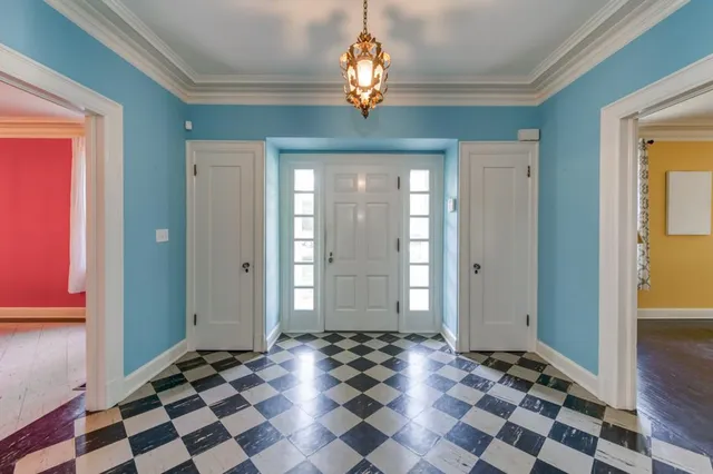 a view of a livingroom with windows and chandelier
