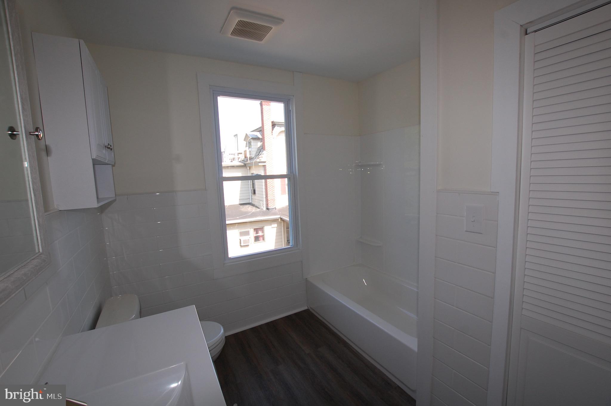 35 East Avenue, Unit 2 Woodstown, NJ 08098 - Photo 7 of 10 a bathroom with a toilet and a window