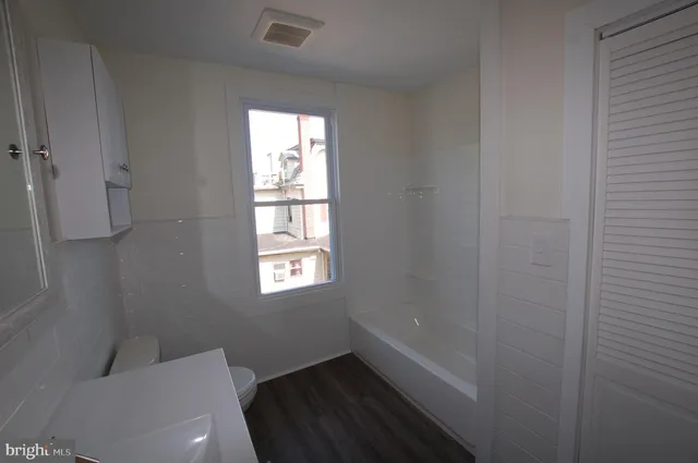 a bathroom with a toilet and a window