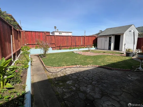 a view of a backyard with table and chairs