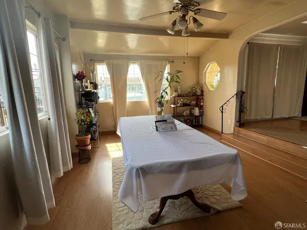 a view of a dining room with furniture and a chandelier