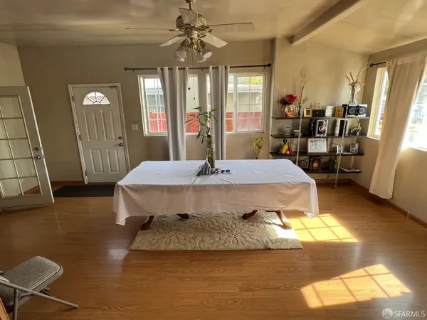 a dining hall with a dining table wooden floor and a fireplace