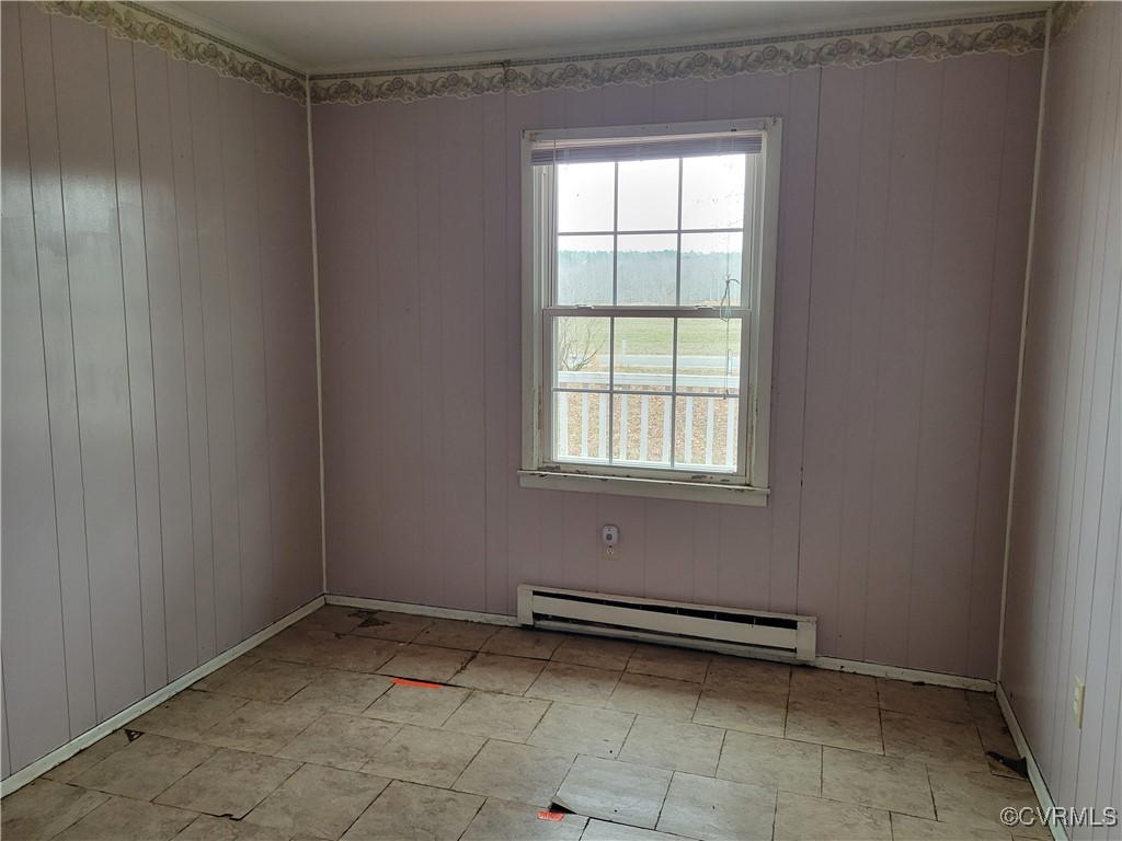 726 Courthouse Drive Saluda, VA 23149 - Photo 10 of 13 Spare room featuring wood walls and a baseboard ra