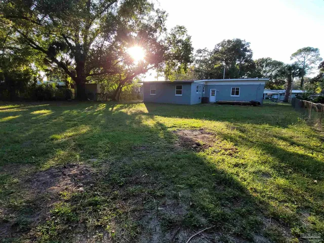 a view of house with yard