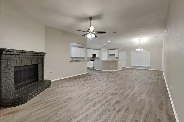 a view of a kitchen with a sink and a fireplace