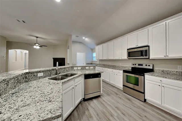 a kitchen with a sink stove and microwave
