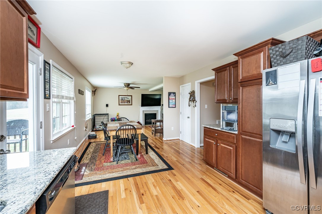 3847 Sage Road Sandy Hook, VA 23153 - Photo 11 of 37 a kitchen with stainless steel appliances granite countertop a refrigerator a stove and a wooden cabinets