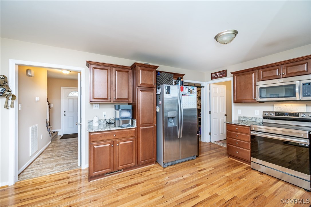 3847 Sage Road Sandy Hook, VA 23153 - Photo 12 of 37 a kitchen with stainless steel appliances granite countertop a refrigerator and a stove top oven
