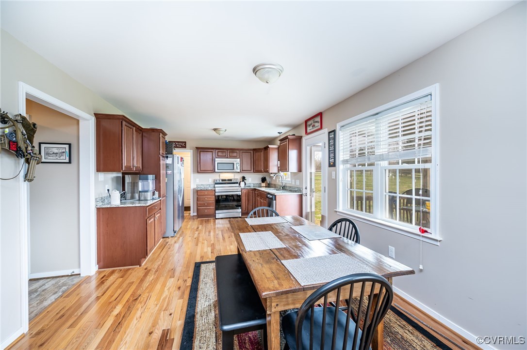 3847 Sage Road Sandy Hook, VA 23153 - Photo 13 of 37 a view of a dining room with furniture window and wooden floor