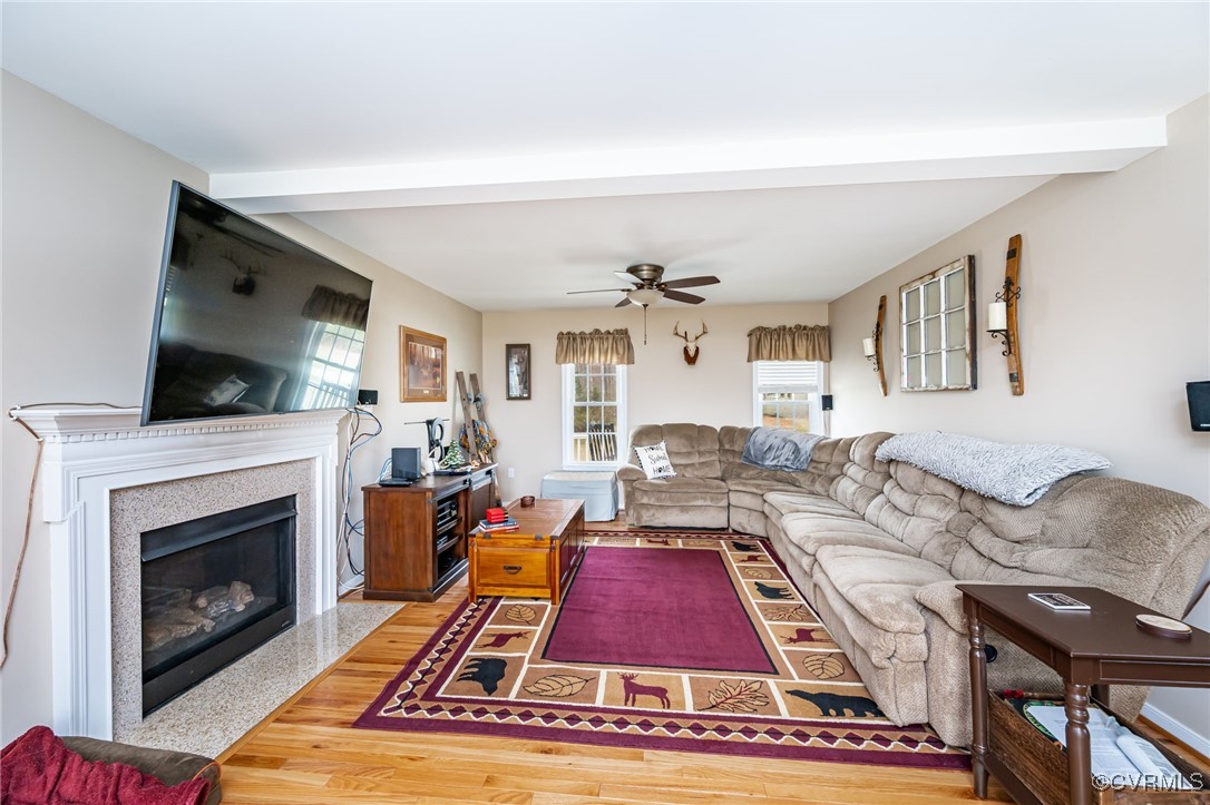 3847 Sage Road Sandy Hook, VA 23153 - Photo 15 of 37 a living room with furniture a rug and a fireplace