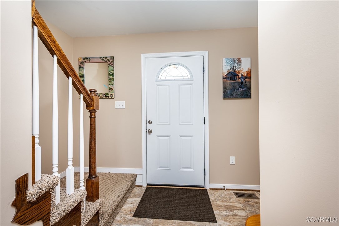 3847 Sage Road Sandy Hook, VA 23153 - Photo 9 of 37 a view of front door with chair and stairs