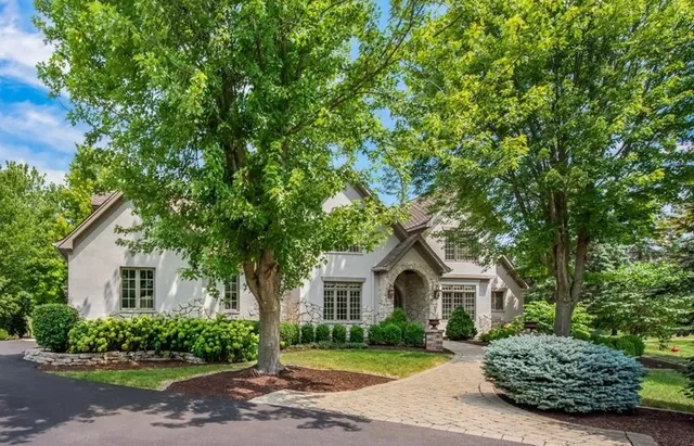 a front view of a house with a garden and yard