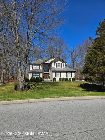 a front view of a building with a garden