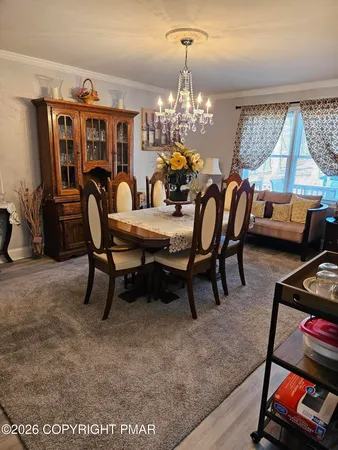 a kitchen with stainless steel appliances granite countertop a table chairs sink and stove