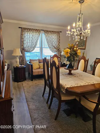 a living room with furniture a piano and a flat screen tv