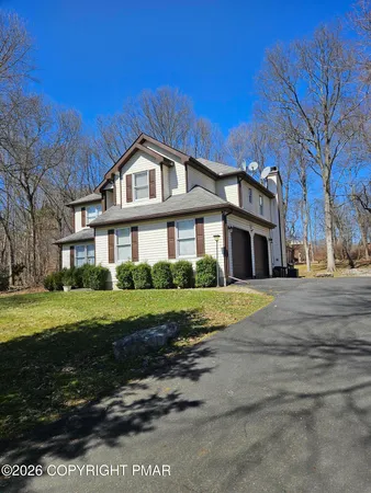 a view of a livingroom with furniture and a mirror