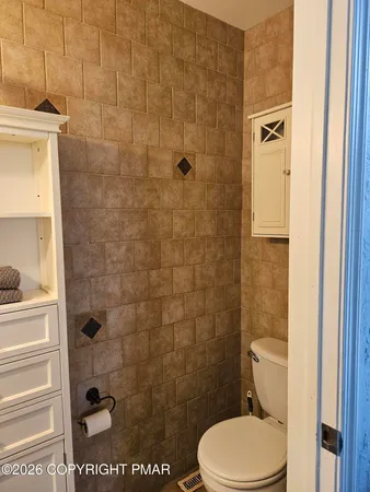 a bathroom with a walk in closet and a window