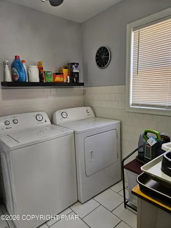 a bedroom with a bed and painting on the wall