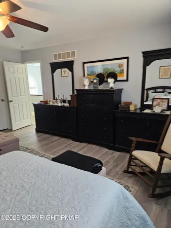 a bedroom with a bed and a dresser