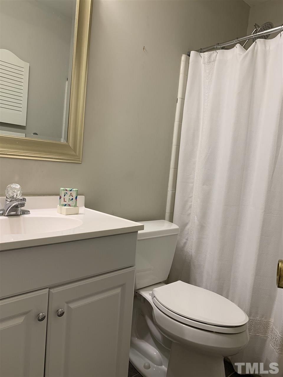 3139 Morningside Drive Raleigh, NC 27607 - Photo 14 of 16 a bathroom with a sink toilet and shower