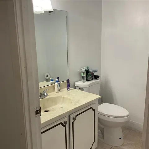 a bathroom with a toilet and a vanity
