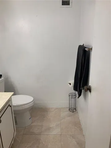a bathroom with a sink toilet and mirror