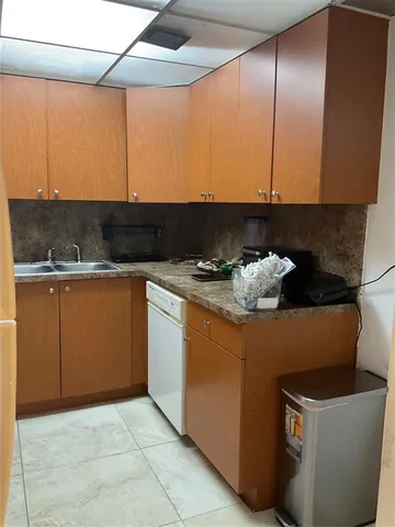 a white refrigerator freezer sitting inside of a kitchen