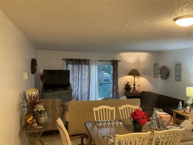 a kitchen with a sink a stove top oven and white cabinets
