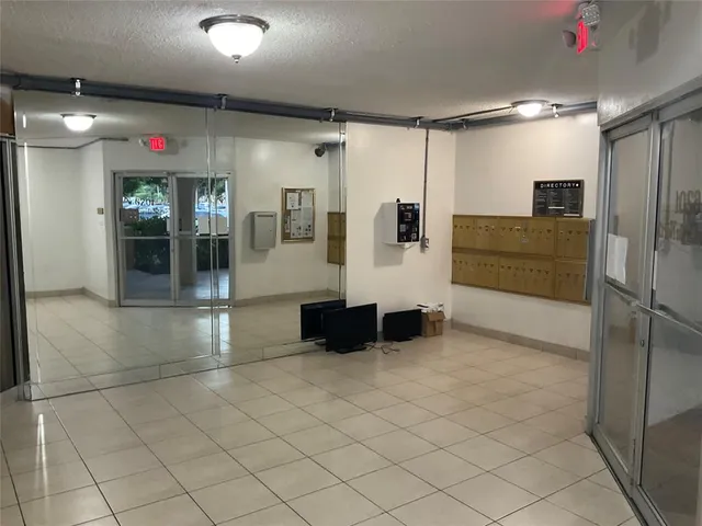 a bathroom with a glass shower door and a mirror