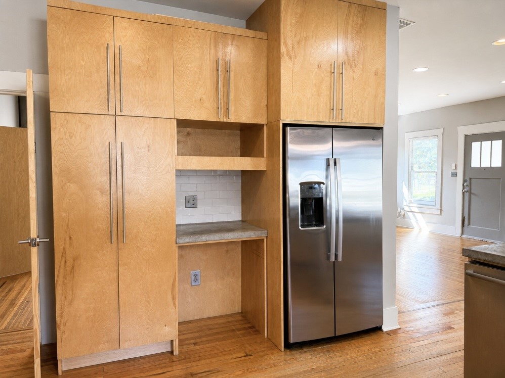 4530 Walker Street Houston, TX 77023 - Photo 2 of 17 a view of a refrigerator in kitchen and wooden floor